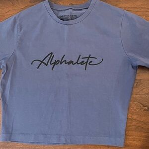 Alphalete Women’s Short Sleeve Crop Tee in Blue with Black Logo